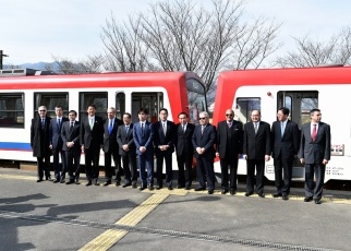 Standing in line in front of a Minamiaso Railway train