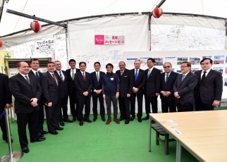 Visiting the Mashiki Reconstruction Food Village in Mashiki Town, where officials are lined up