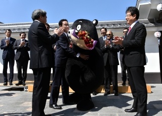 Minister Kishida hugging Kumamon