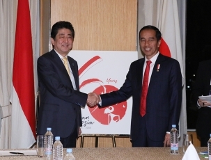Prime Minister shaking hands with the President of Indonesia