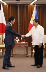 Prime Minister shaking hands with the President of the Philippines