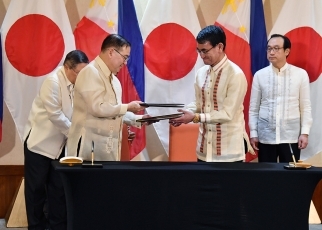 Mr. Kono and H.E. Mr. Locsin who exchange the notes