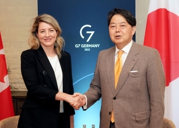 Minister Hayashi and Minister Joly who shake hands facing straight at the camera