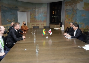 Two Ministers who have a talk after having a seat at a table