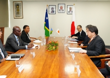 Two Ministers who have a talk after having a seat at a table