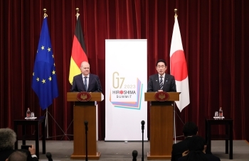 Two leaders who hold a joint press conference standing behind a lectern