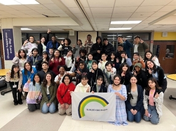 Participants meeting with local students