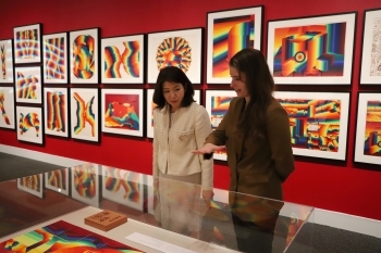 Mrs. Kishida redeives an explanation about the 100th anniversary commemorative exhibition by the staff