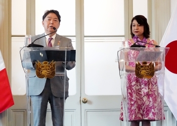 Two Ministers who attend a joint press announcement standing behind the lectern