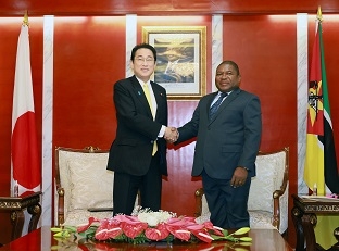 Two leaders who shake hands facing straight at a camera