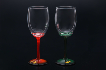 Two wine glasses which are applied makie (Japanese lacquer sprinkled with gold powder) on their foot (their color are red and green from its stem to foot)