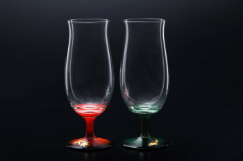 Two goblets glasses which are applied makie (Japanese lacquer sprinkled with gold powder) on their foot (their color are red and green from its stem to foot)