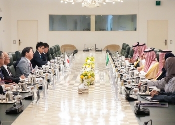 Two Ministers who have a talk after having a seat at a table