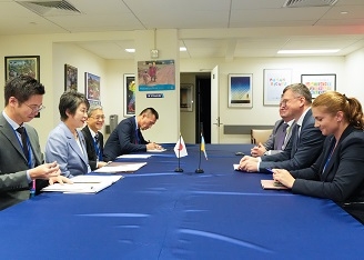 Two Ministers who have a talk after having a seat at a table