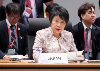 Minister Kamikawa who remarks in the outreach session on supply chain resilience after having a seat at a table