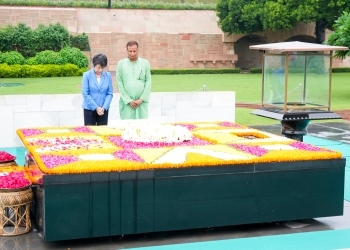 Foreign Minister Kamikawa prays a moment of silence at the Raj Ghat
