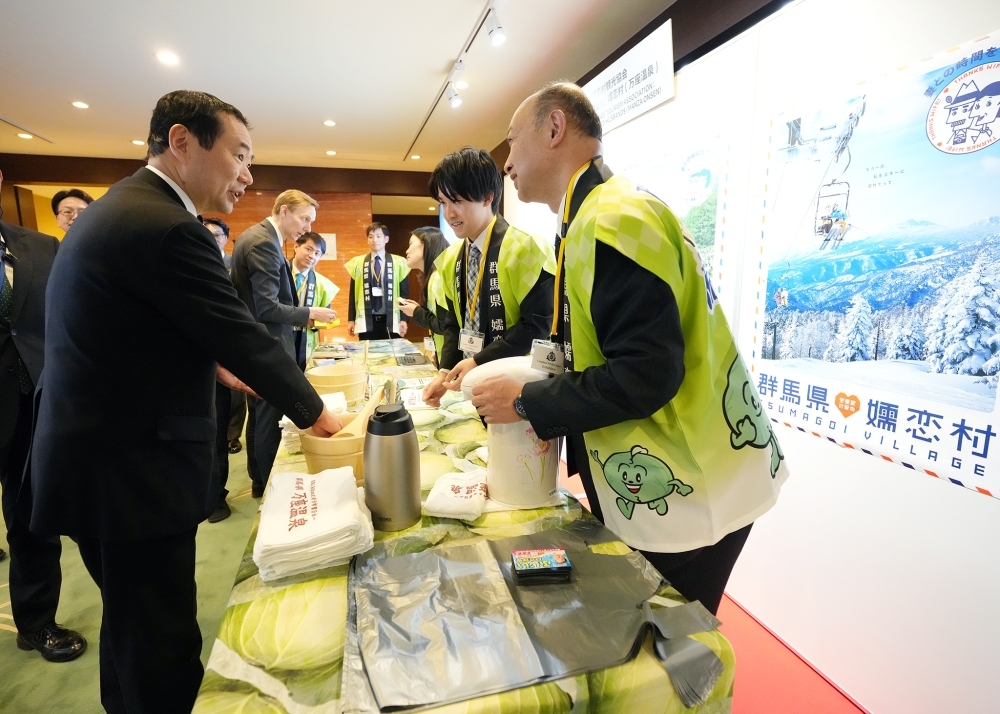 State Minister for Foreign Affairs Fujii inspecting the booth