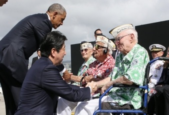 President Obama and Prime Minister Abe exchange words with attendees