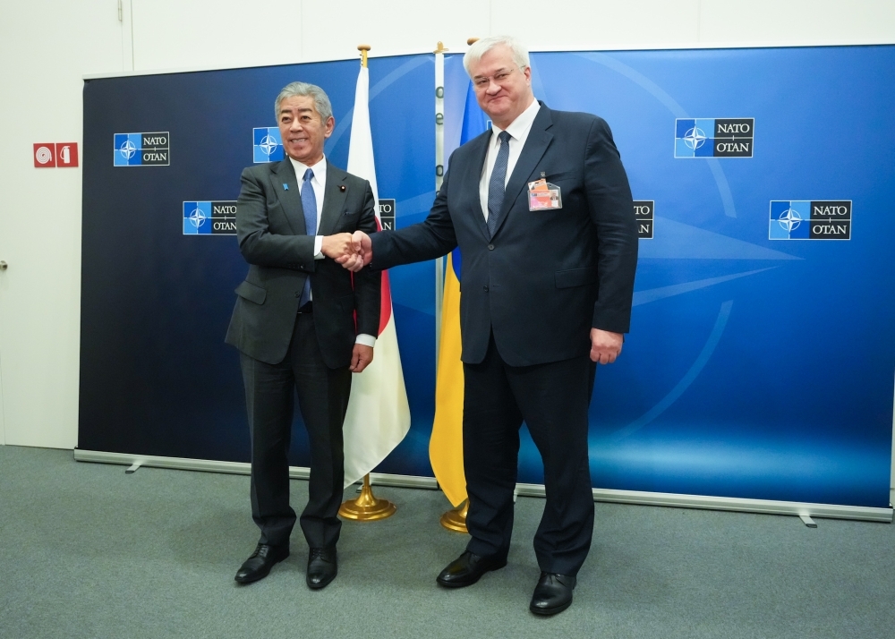 Foreign Minister Iwaya shaking hands with Foreign Minister Sybiha