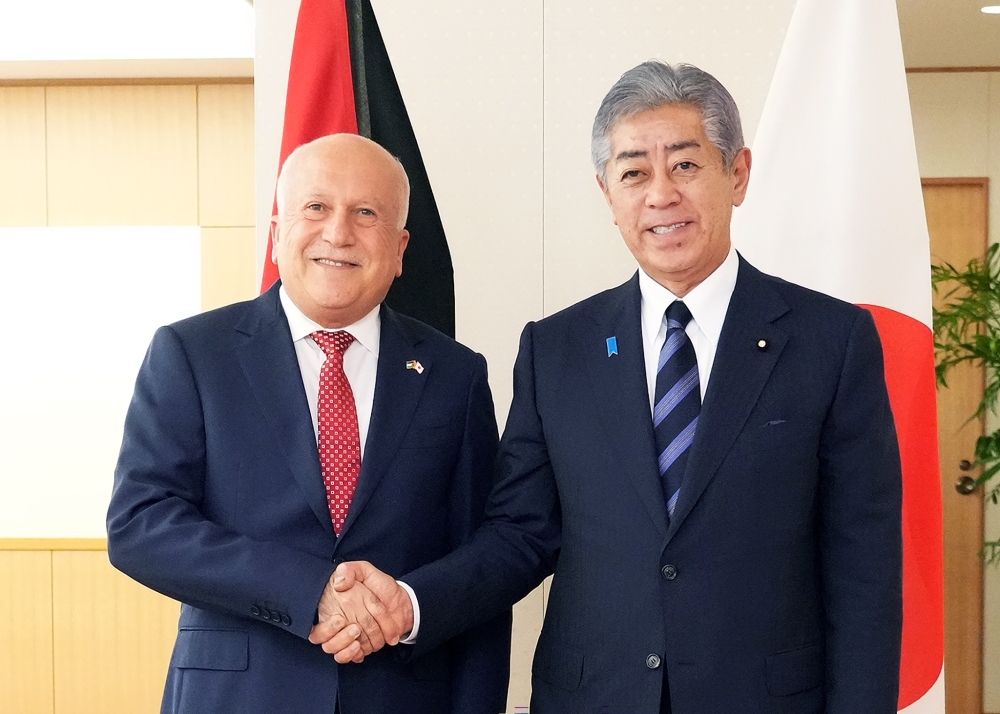 Foreign Minister IWAYA shaking hands with Mr. Al-Amour, Minister of National Economy of Palestine