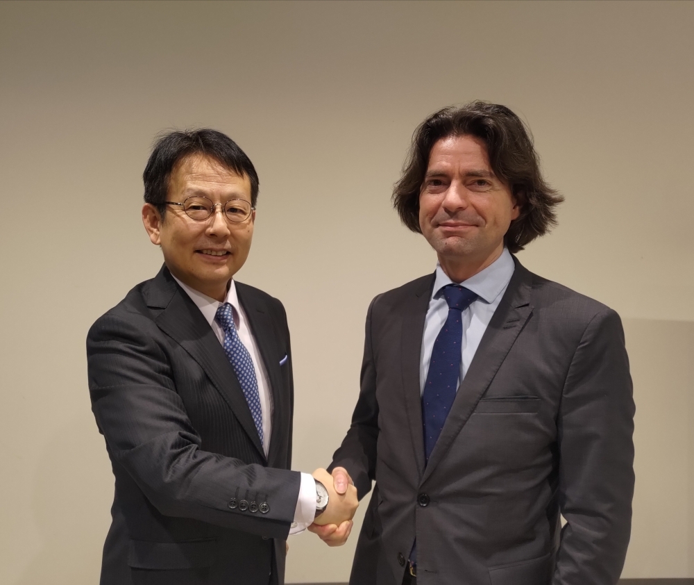 Ambassador NAKAMURA shaking hands with Mr. OLLAGNIER, Director for Strategic Affairs, Security, and Disarmament