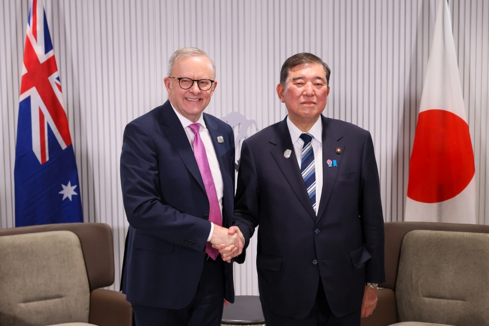 Prime Minister Ishiba shaking hands with Prime Minister Albanese