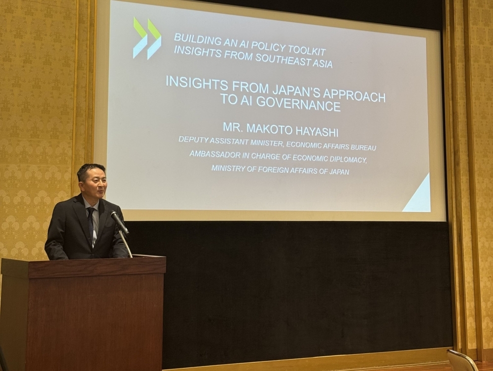 Mr. Hayashi speeking from a podium