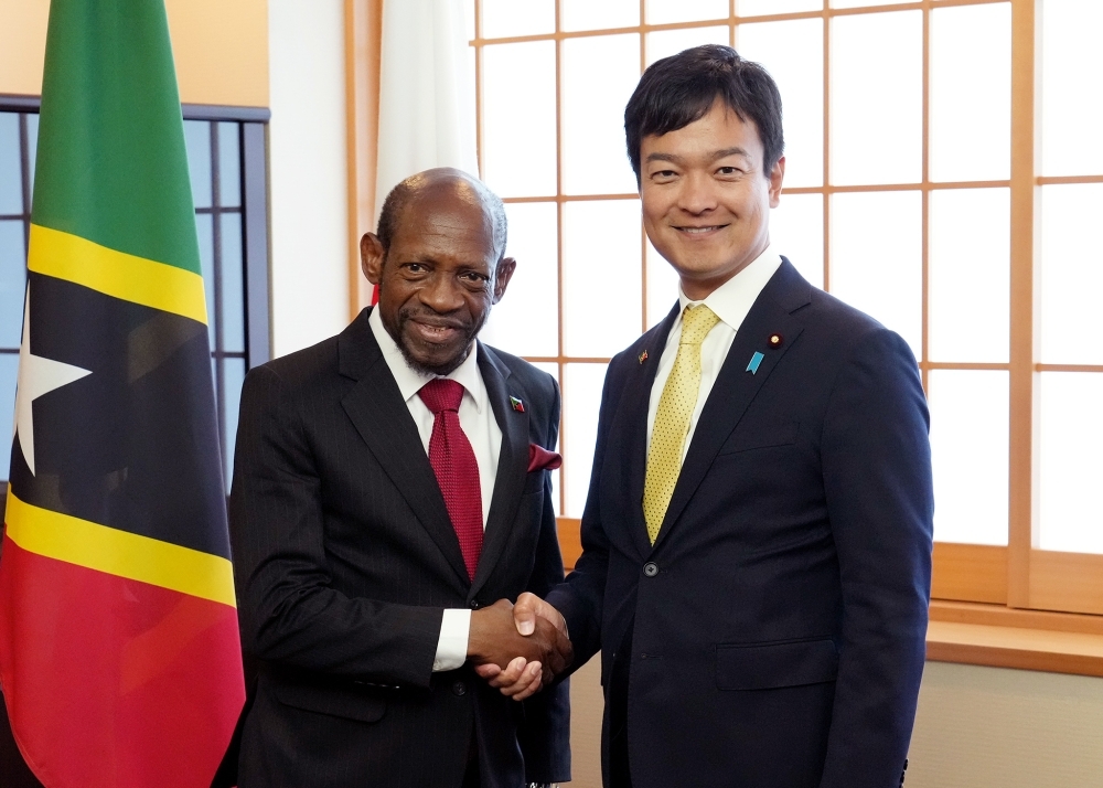 State Minister Miyaji shaking hands with Minister Douglas