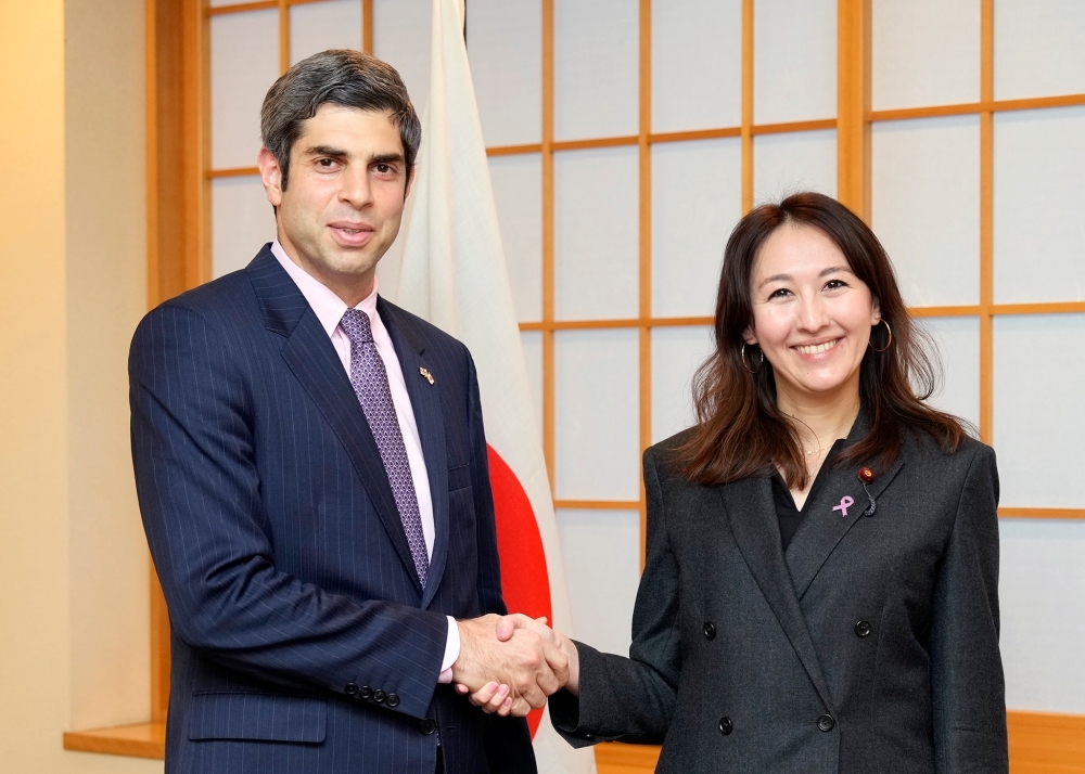 Parliamentary Vice-Minister Eri shaking hands with Ambassador Lezhava