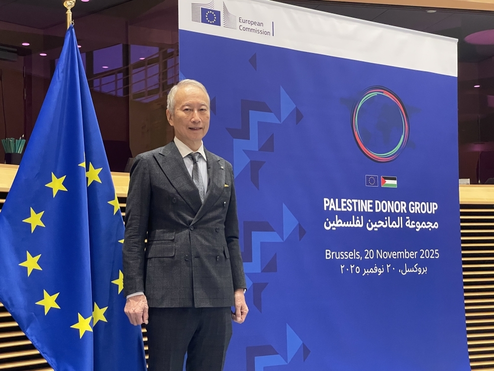 Ambassador in charge of Gaza Rebuilding Assistance Mr. OKUBO standing in front of the sign for the Senior Officials’ Meeting of the Palestine Donor Group