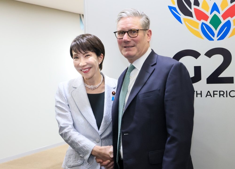 Prime Minister Takaichi shaking hands with Prime Minister Starmer