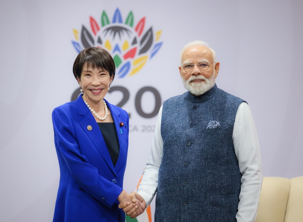 Prime Minister Takaichi shaking hands with Prime Minister Modi