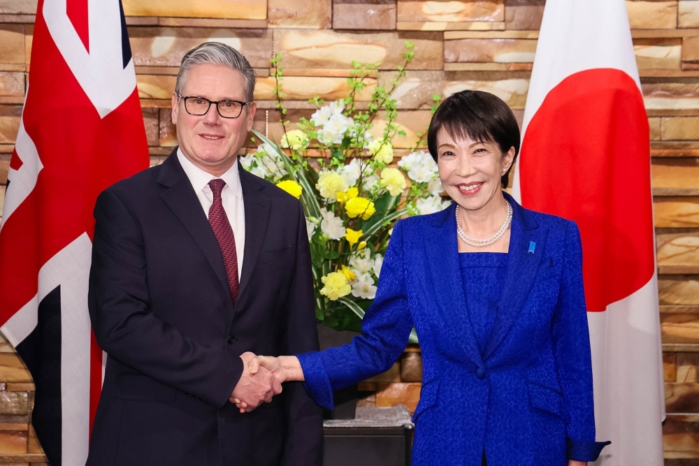 Prime Minister TAKAICHI shaking hands with Prime Minister Starmer