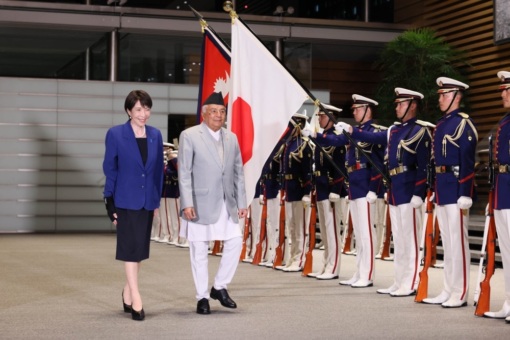 Prime Minister Takaichi and President Paudel marching past the honor guard