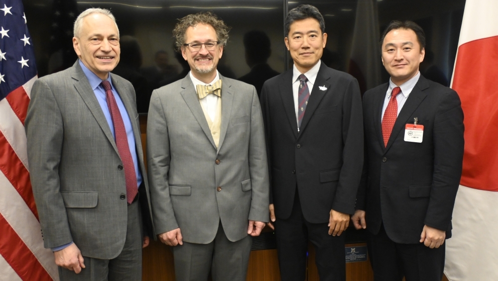 Two American members and two Japanese members of each delegation's taking photo
