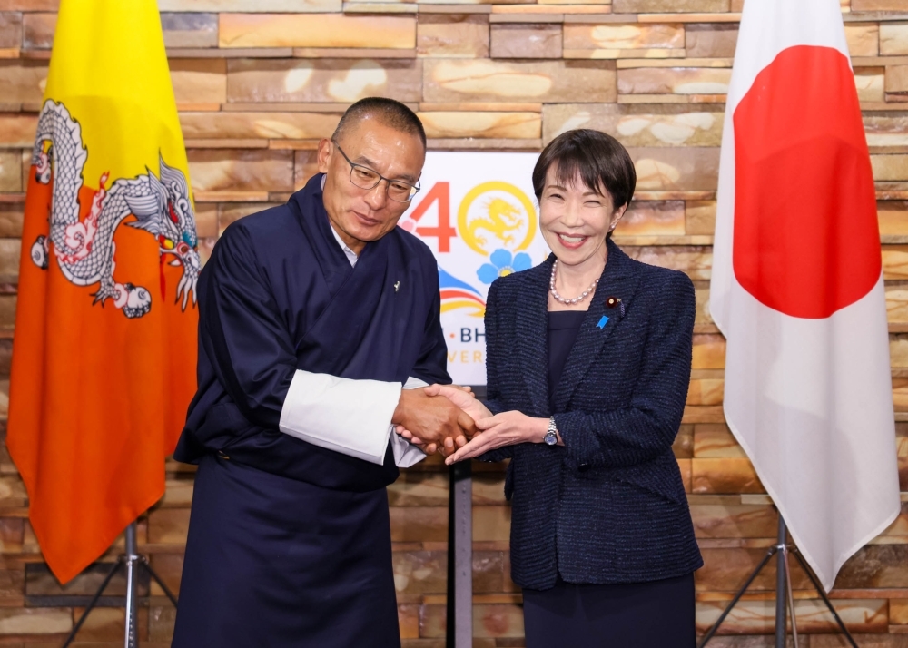 Prime Minister TAKAICHI shaking hands with Prime Minister Tobgay