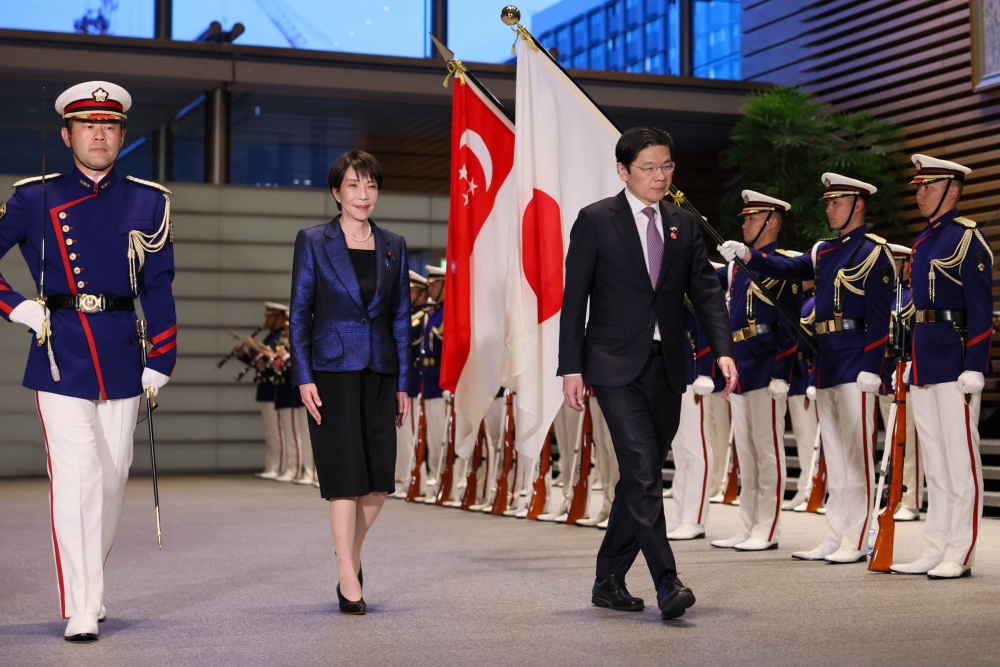 Prime Minister TAKAICHI and Prime Minister Wong walking in front of the honor guard