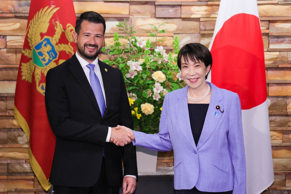 Prime Minister Takaichi shaking hands with President Milatović