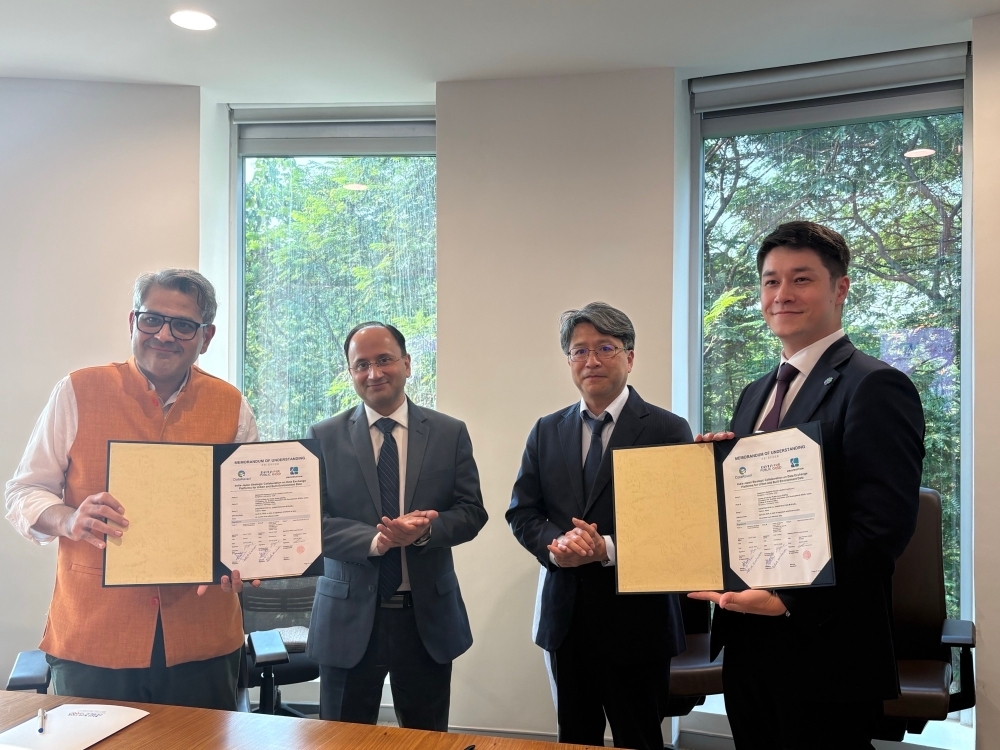 Representatives from both sides posing for a photo with the MOU