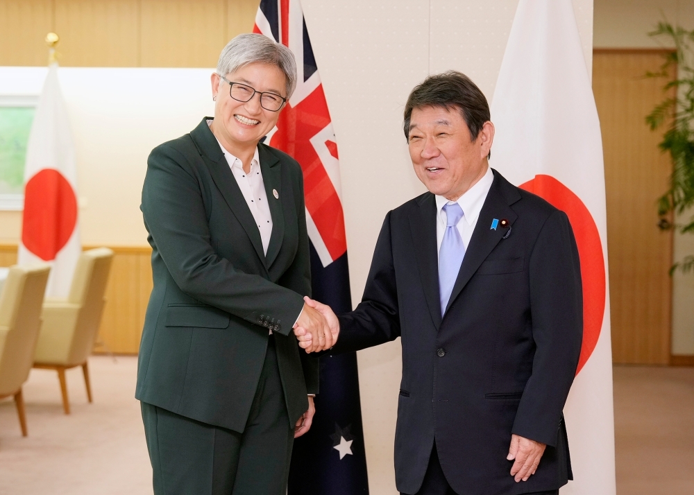 Foreign Minister MOTEGI shaking hands with Senator the Hon. WONG, Minister for Foreign Affairs of Australia