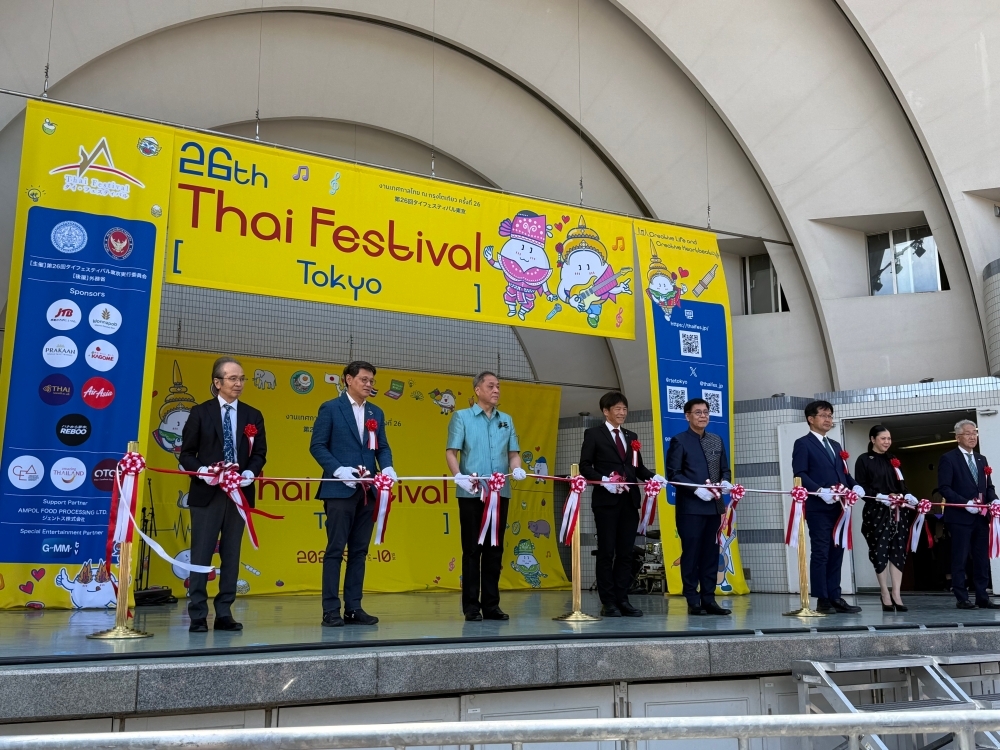 Attendees at the opening ceremony cutting the tape on stage
