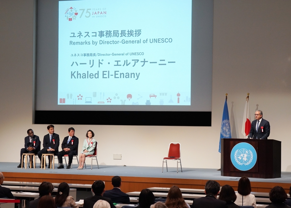 Foreign Minister MOTEGI seated on stage as a speaker, listening to the presentations of the other speaker