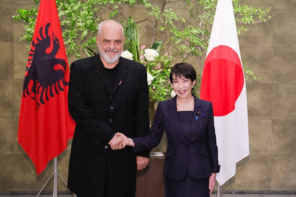 Prime Minister Takaichi shaking hands with Prime Minister Rama
