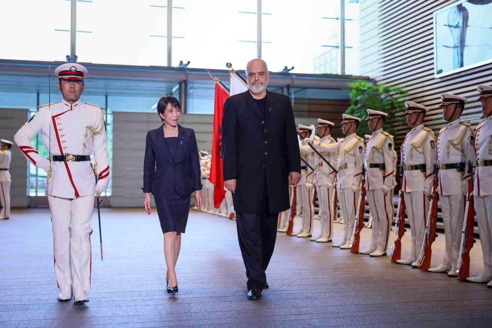 The two leaders walking in front of the honor guard
