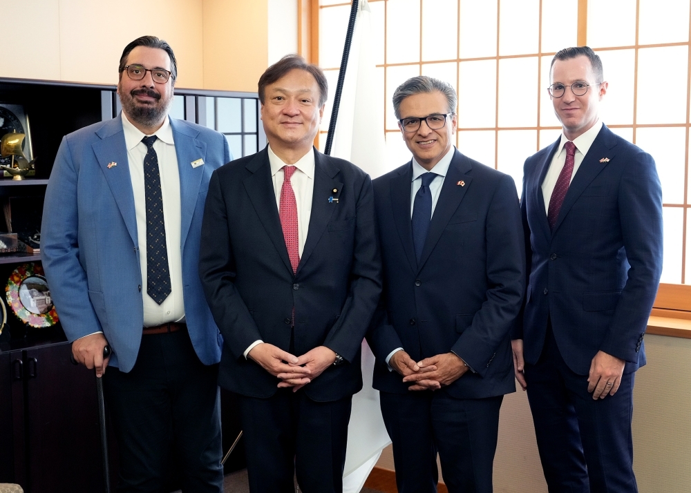 Group photo: State Minister HORII, President and CEO HYDER, and two members of the 