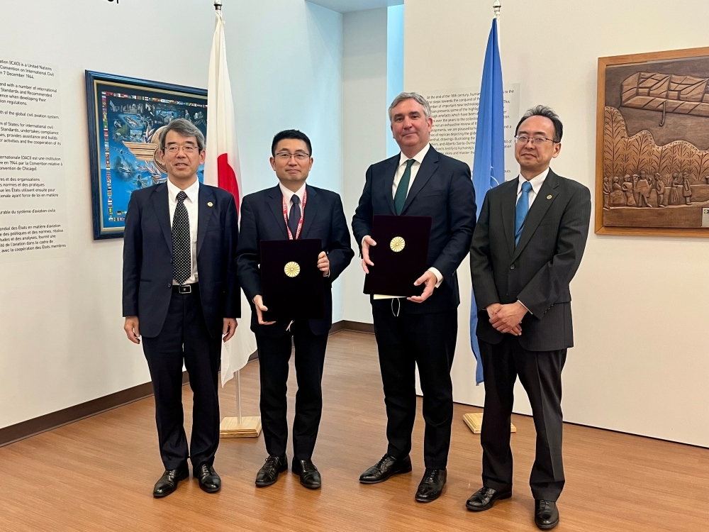 Japanese officials and ICAO officials taking photo showing the deposited instruments of ratification of the protocols