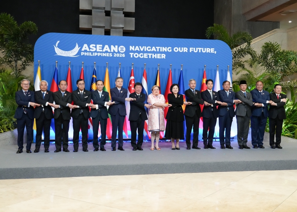 ASEAN Plus 3 Foreign Ministers on the stage shaking hands with each other