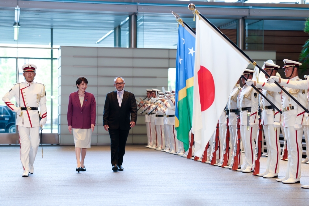 The two leaders walking in front of the honor guard