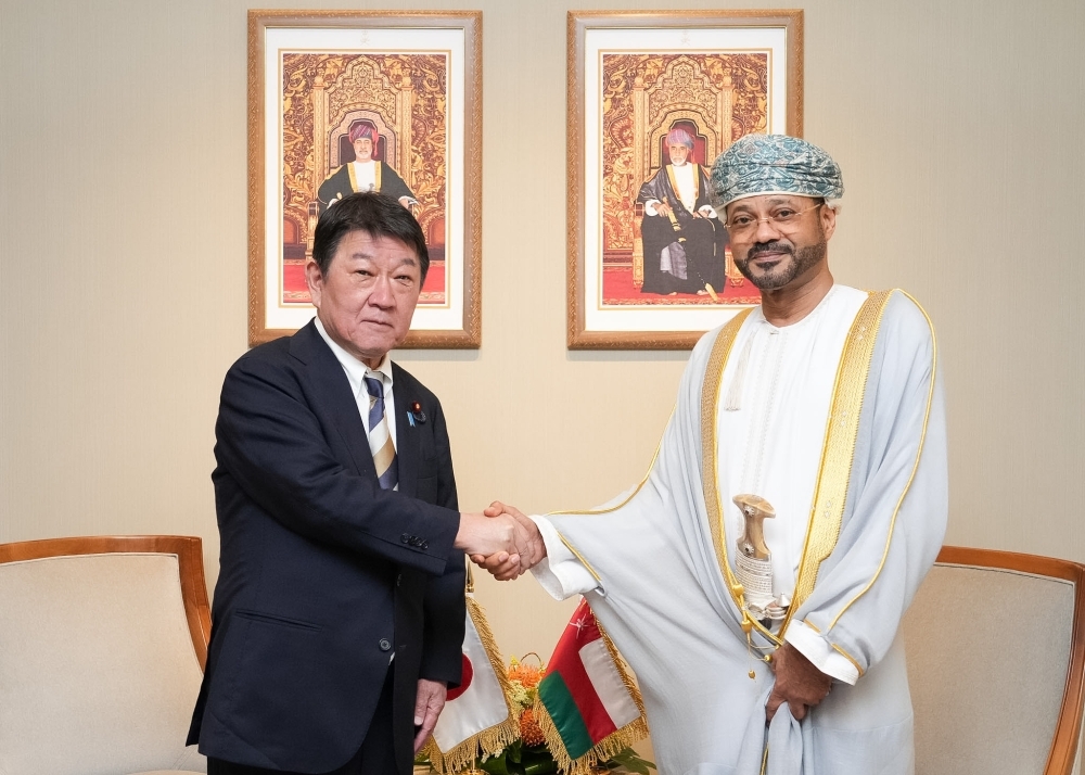 Foreign Ministers MOTEGI shaking hands with  with H.E. Mr. Badr, Minister of Foreign Affairs of Oman