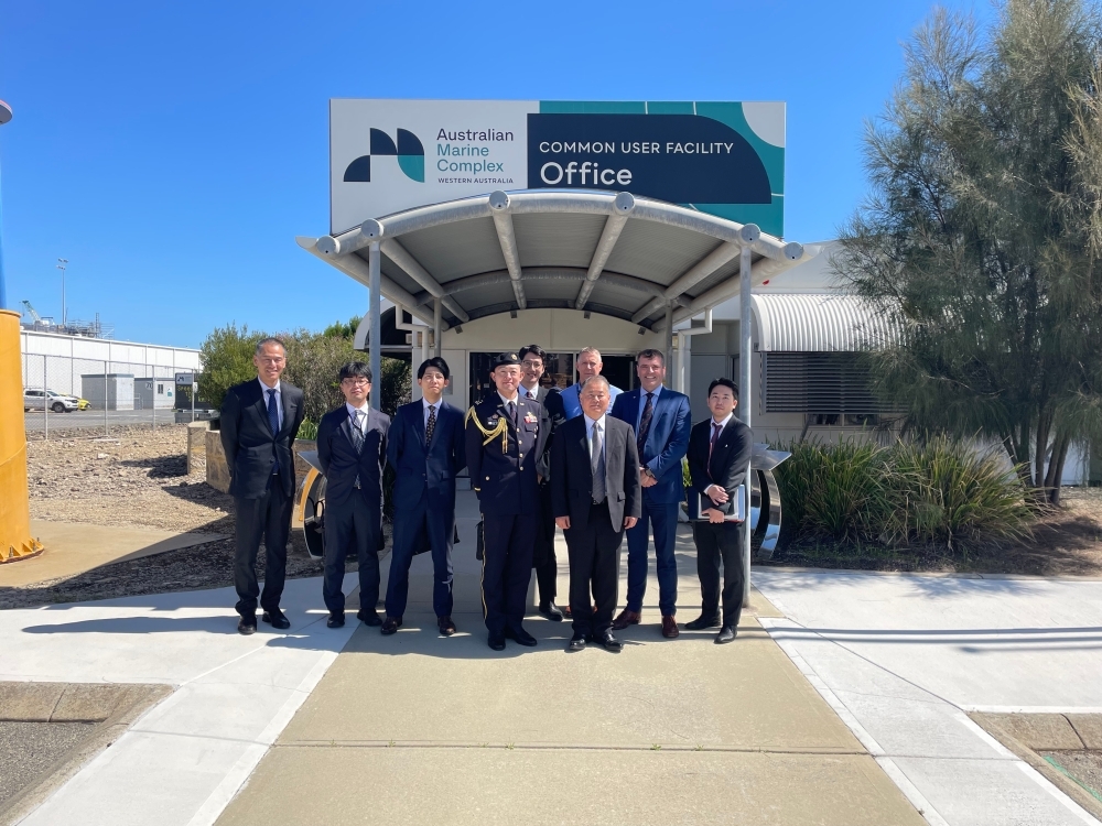 Special Advisor OUE and associates taking a commemorative photo in front of the COMMON USER FACILITY OFFICE
